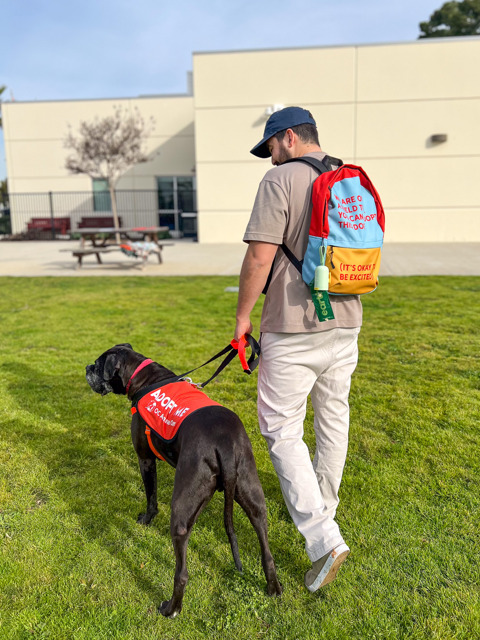 Dog's Day Out Participant holding with dog in harness and leash
