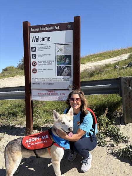 Volunteer with a shelter dog during OCAC Dog's Day Out.